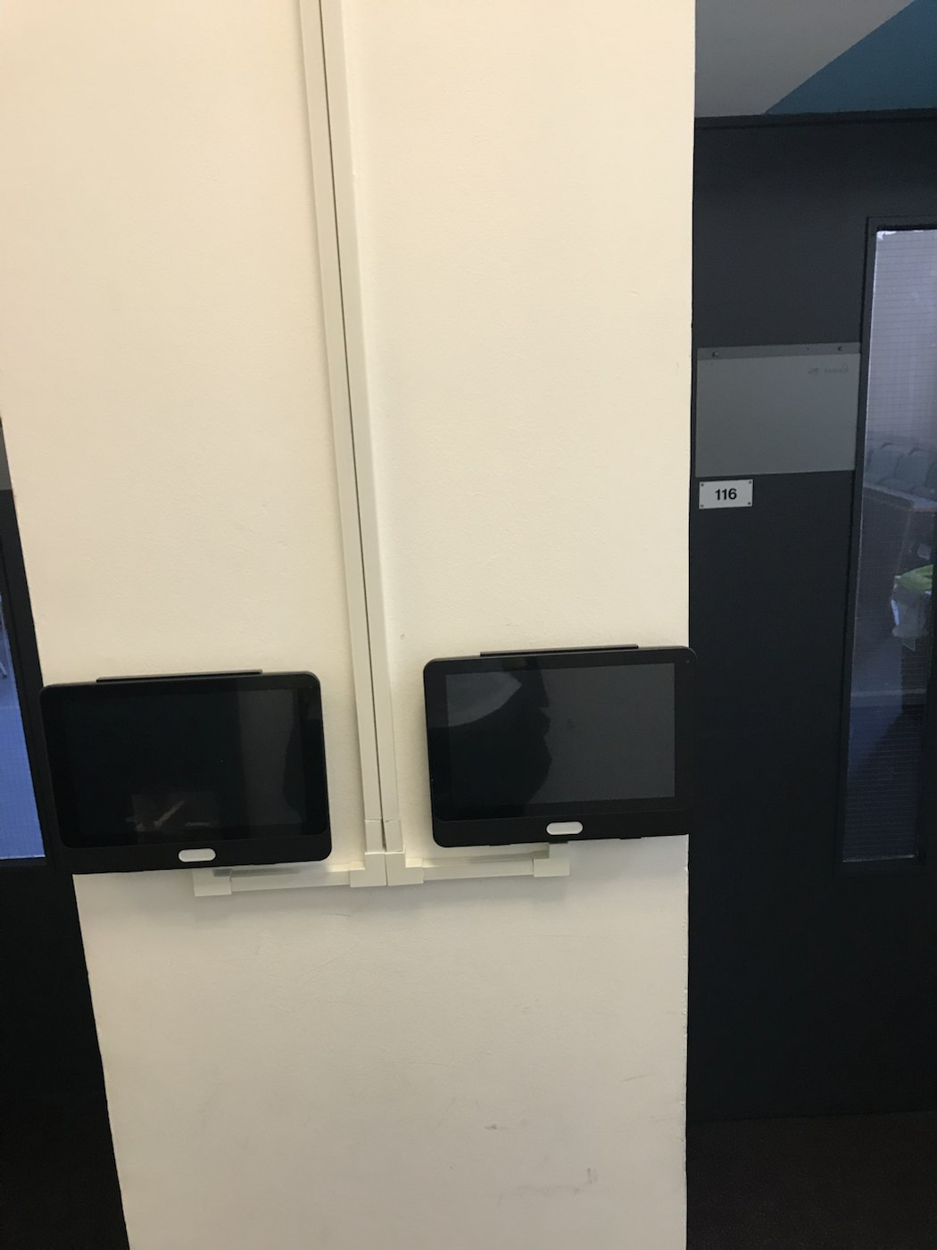 Two NFC attendance devices installed side by side during installation